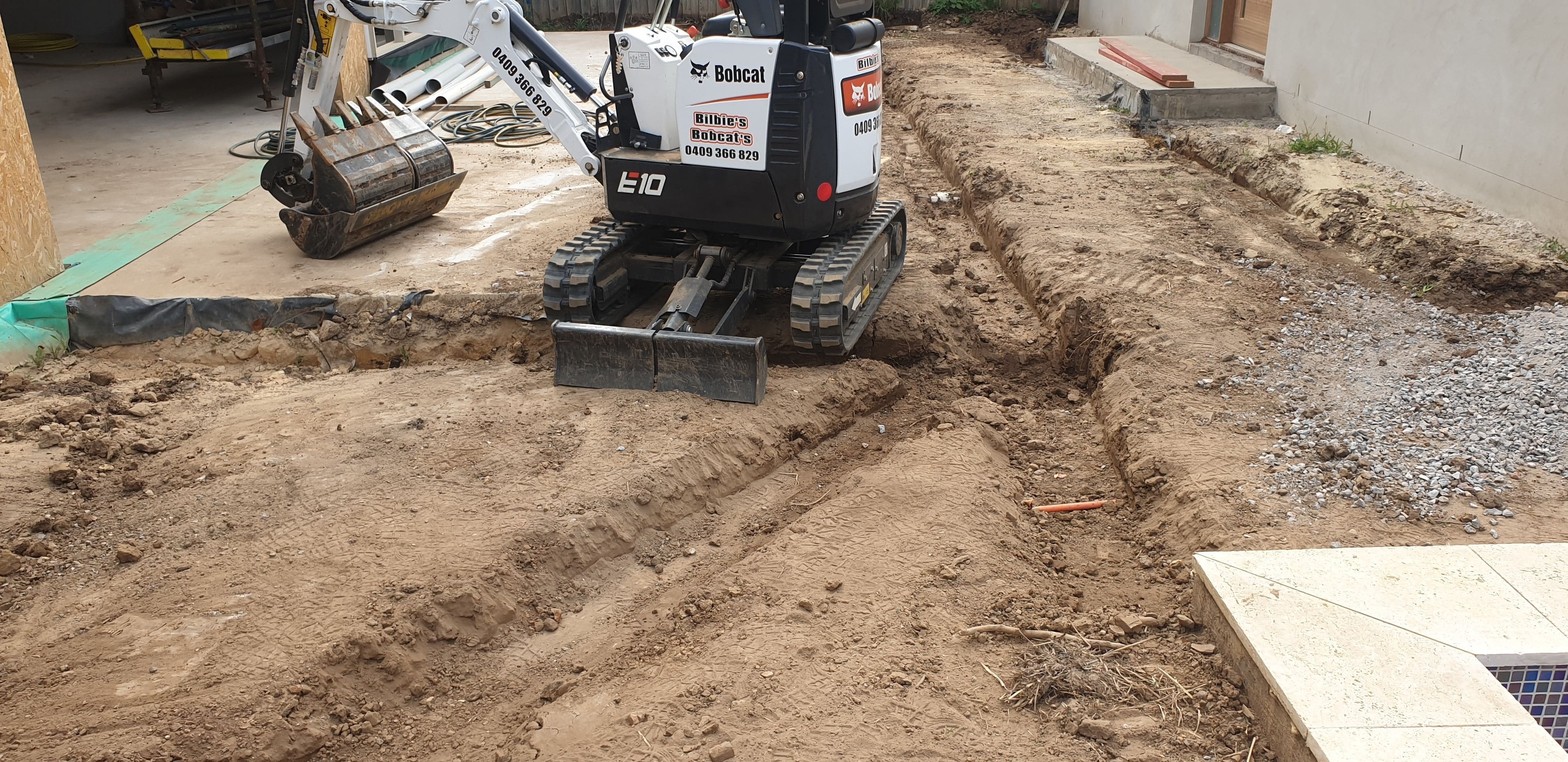 Mini excavator digging footings