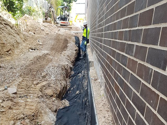 Excavator working digging trenches with machine hire in gladsville